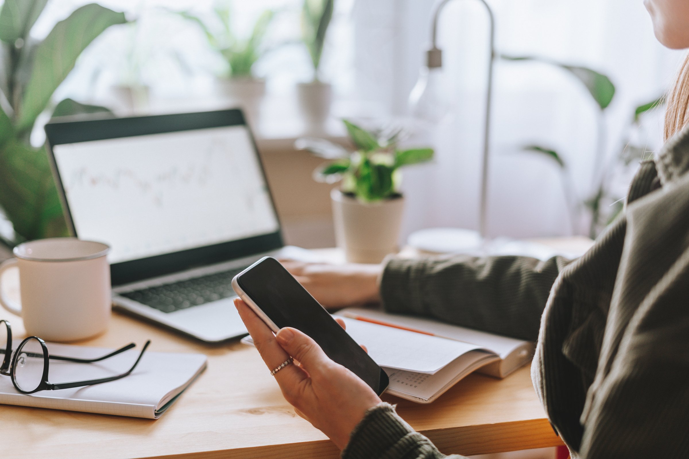 Woman with laptop and phone